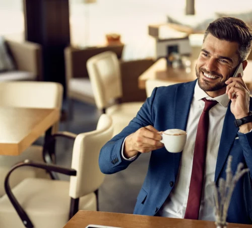 Al Shirawi happy businessman drinking coffee scaled